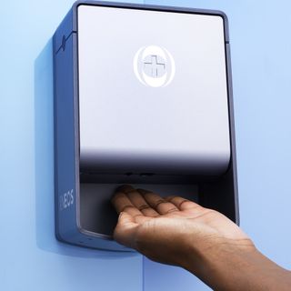 hand sanitizer with blue wall and hand