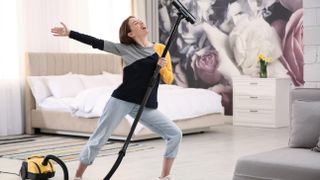 Woman cleaning with vacuum cleaner