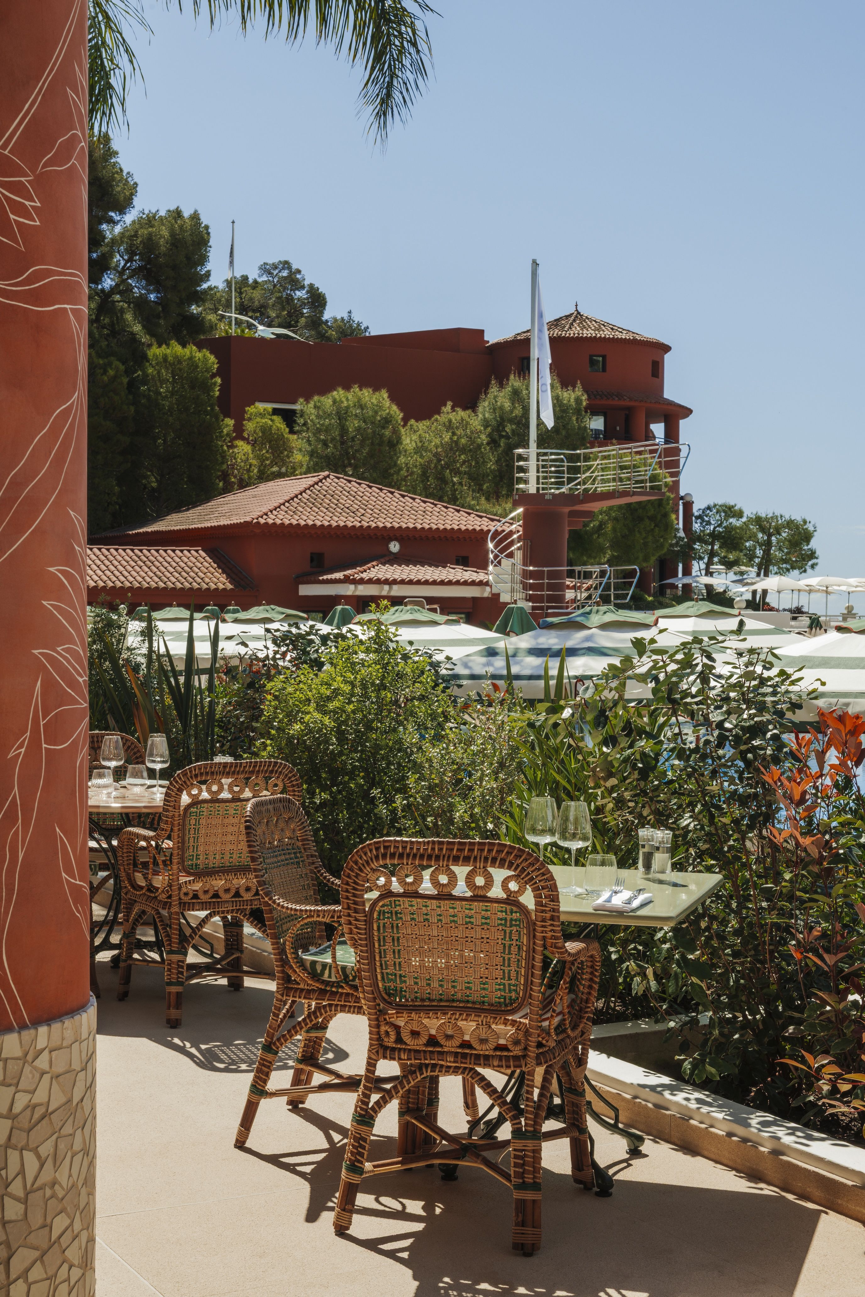Colorful nistro chairs sit on a patio at Monte-Carlo Beach resort.