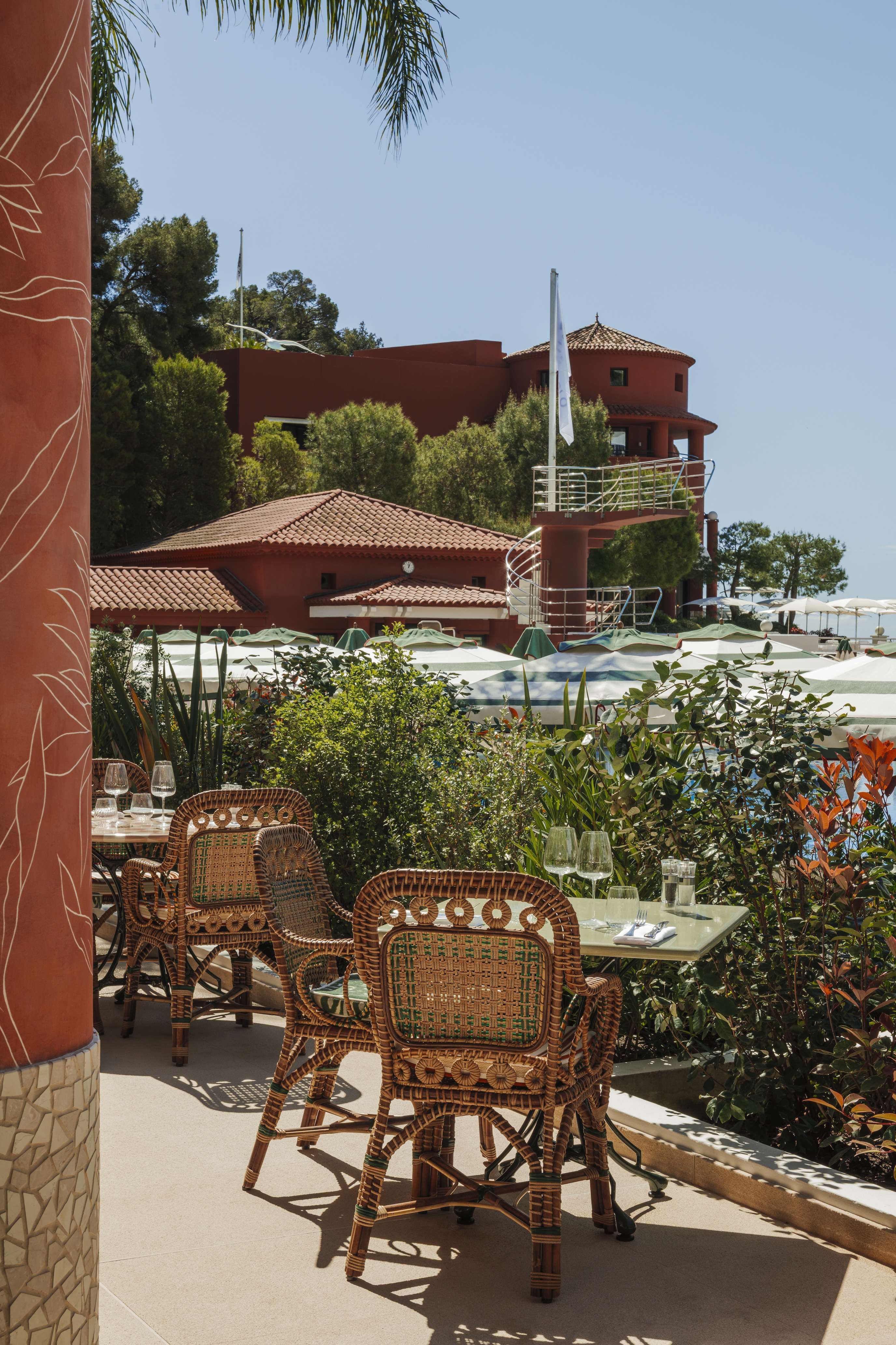 Colorful nistro chairs sit on a patio at Monte-Carlo Beach resort.