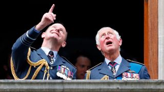 Air Chief Marshal Sir Mike Wigston, Chief of the Air Staff and Prince Charles, Prince of Wales watch a Spitfire and Hurricane fly-past from the balcony of Church House after attending the Battle of Britain 81st Anniversary Service of Thanksgiving and Rededication at Westminster Abbey on September 19, 2021 in London, England