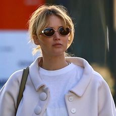 Jennifer Lawrence was seen heading to Zinqué in West Hollywood, wearing a white T-shirt, black pants, moccasins, and a cream satin jacket while pregnant.