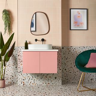 bathroom with pink tiled walls and plant in pot