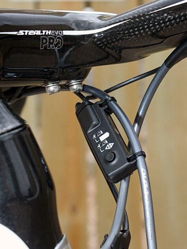 A small control box is attached to the brake housing and provides the interface for derailleur adjustments and battery life indicators.
