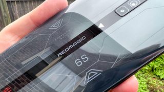 redmagic 6s pro review: phone in hand showing redmagic logo