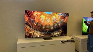 Samsung 85-inch QN900D 8K QLED TV on its stand on the CES show floor