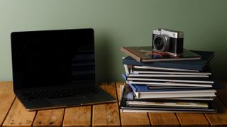 A stack of various photo books on a desk