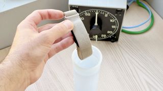 Close-up of the Garmin Cirqa fitness tracker being submerged in water to test its water resistance