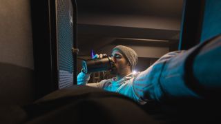 Man drinks pre-workout in gym locker room