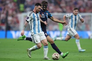 Lionel Messi (L) fights for the ball with Croatia's defender #20 Josko Gvardiol during the Qatar 2022 World Cup football semi-final match between Argentina and Croatia at Lusail Stadium in Lusail, north of Doha on December 13, 2022.