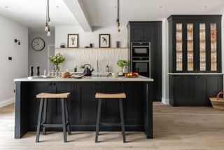 Porcelain wood kitchen flooring ideas in a monochrome scheme with breakfast bar.