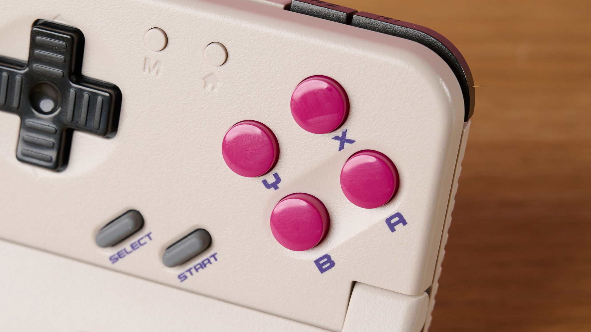 A closeup of the GameSir Pocket Taco 's buttons, showing the X, Y, B, A, Start, Select, M and Home buttons, as well as the D-pad.