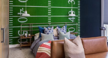 boys bedroom ideas with sporty wall mural and blue double bed