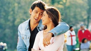 a man in a denim jacket puts his arm around a woman in a pink shirt in a still from the movie Mujhse Dosti Karoge