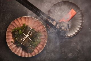 Trout and Caviar dish amid smoke from cooking at Humo Mayfair restaurant London