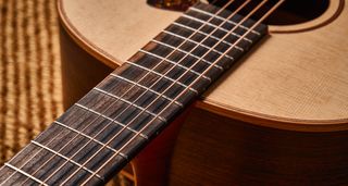 The fingerboard of the Lowden F-12 Spruce Top acoustic guitar