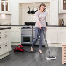 Woman cleaning a wooden floor with the Ewbank Steam Dynamo cleaner