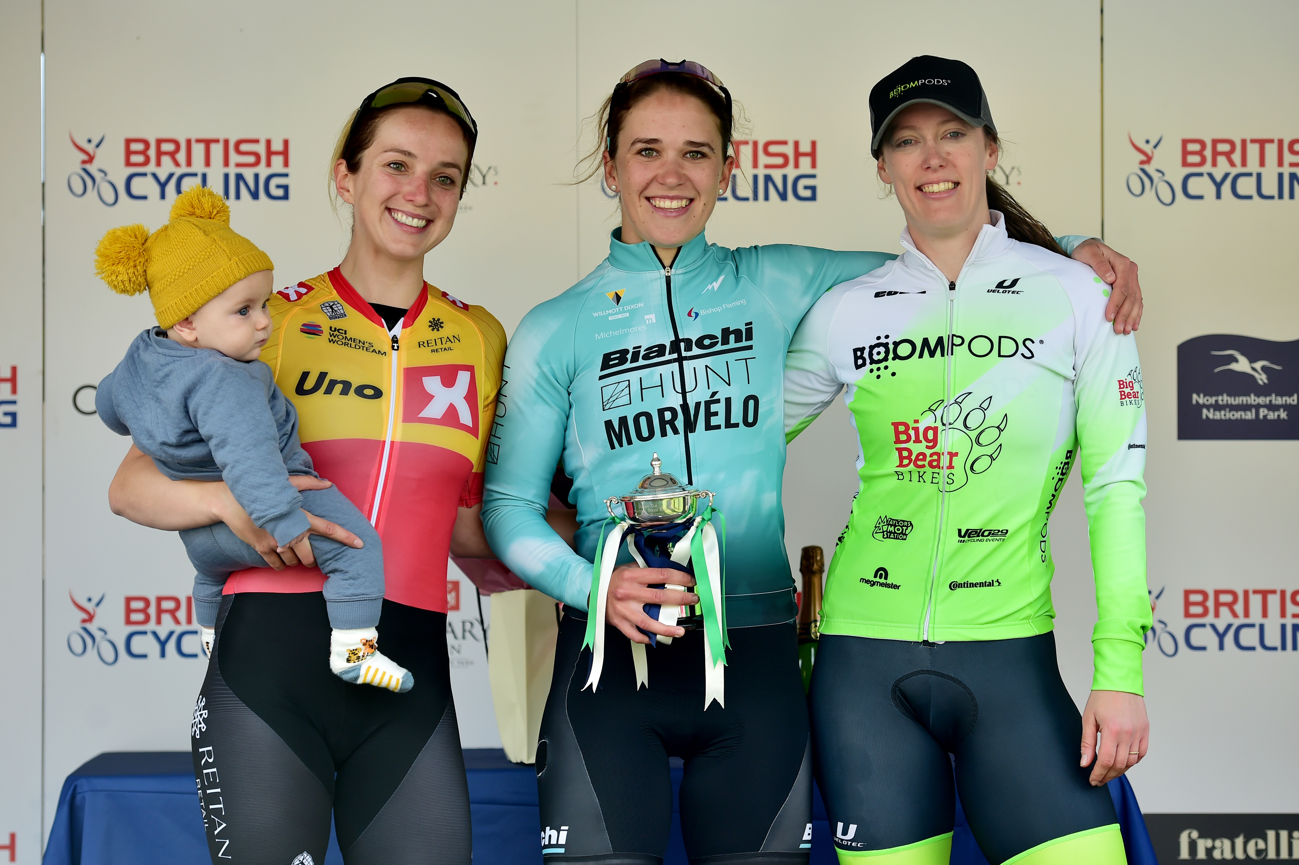 Elinor Barker on a podium with her son Nico