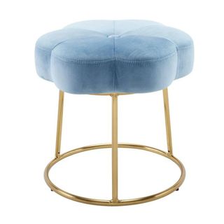 An aqua blue velvet stool shaped like a flower, with a circular gold metal hardware base