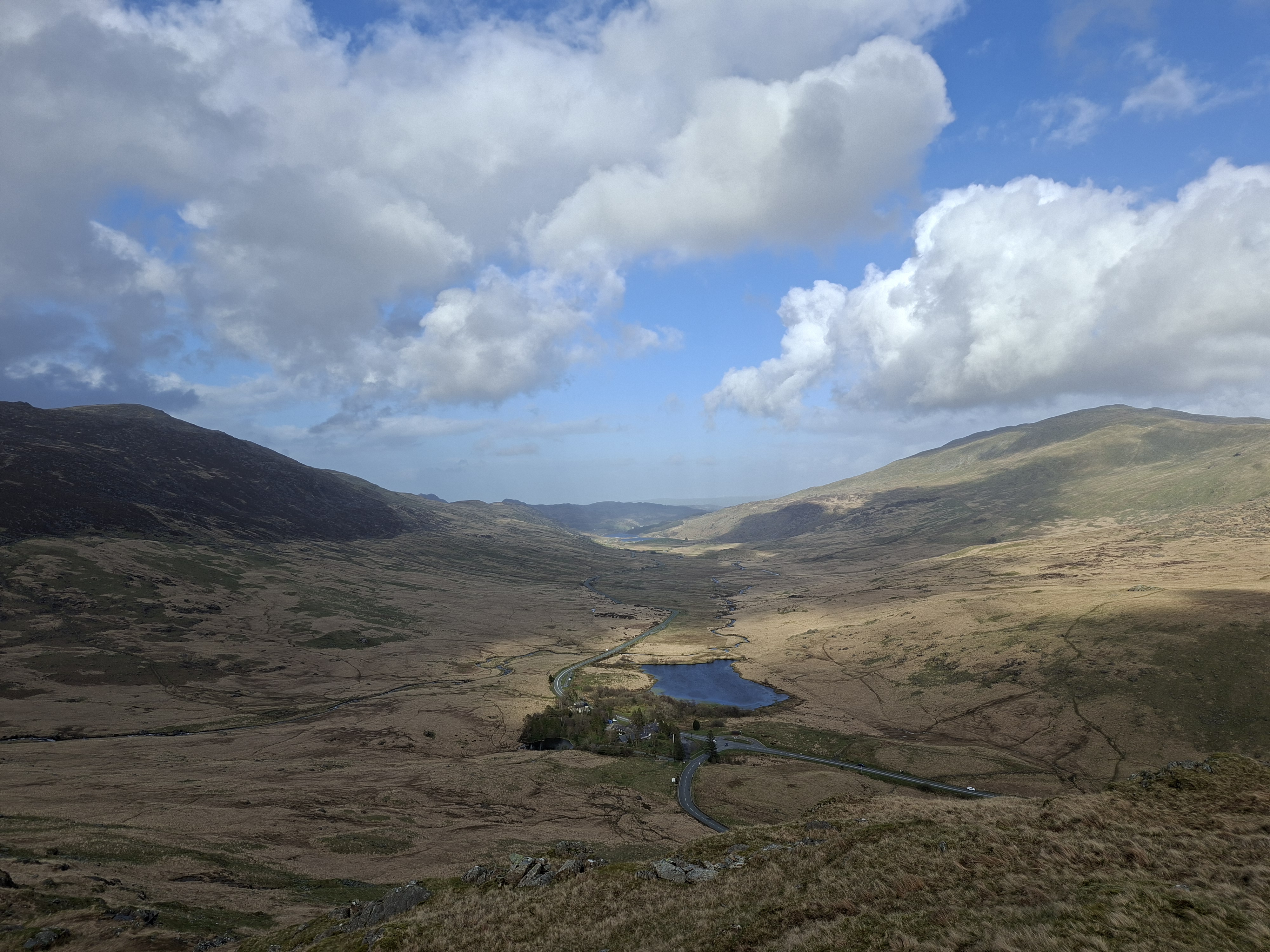 A photo taken on the Samsung Galaxy A57 showing some hills and a lake.
