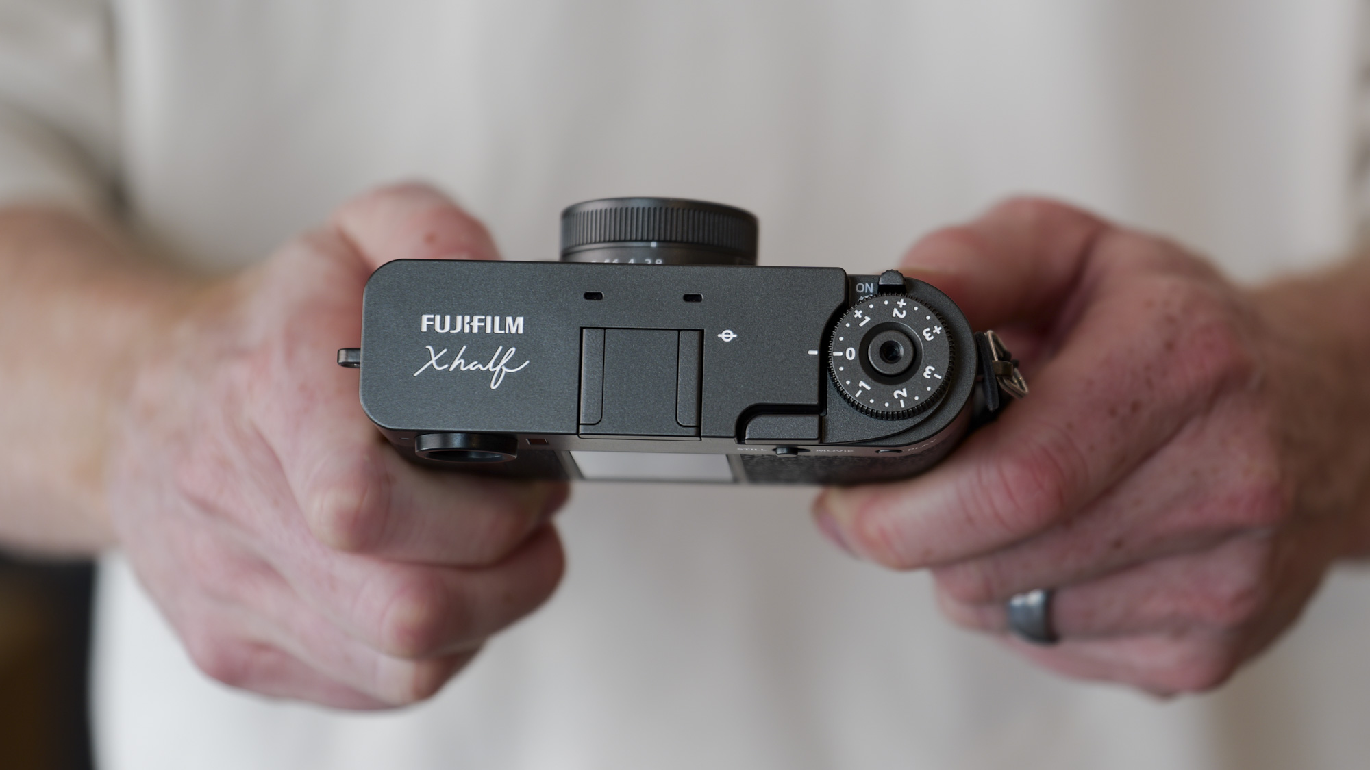 Fujifilm X half compact camera in the hand