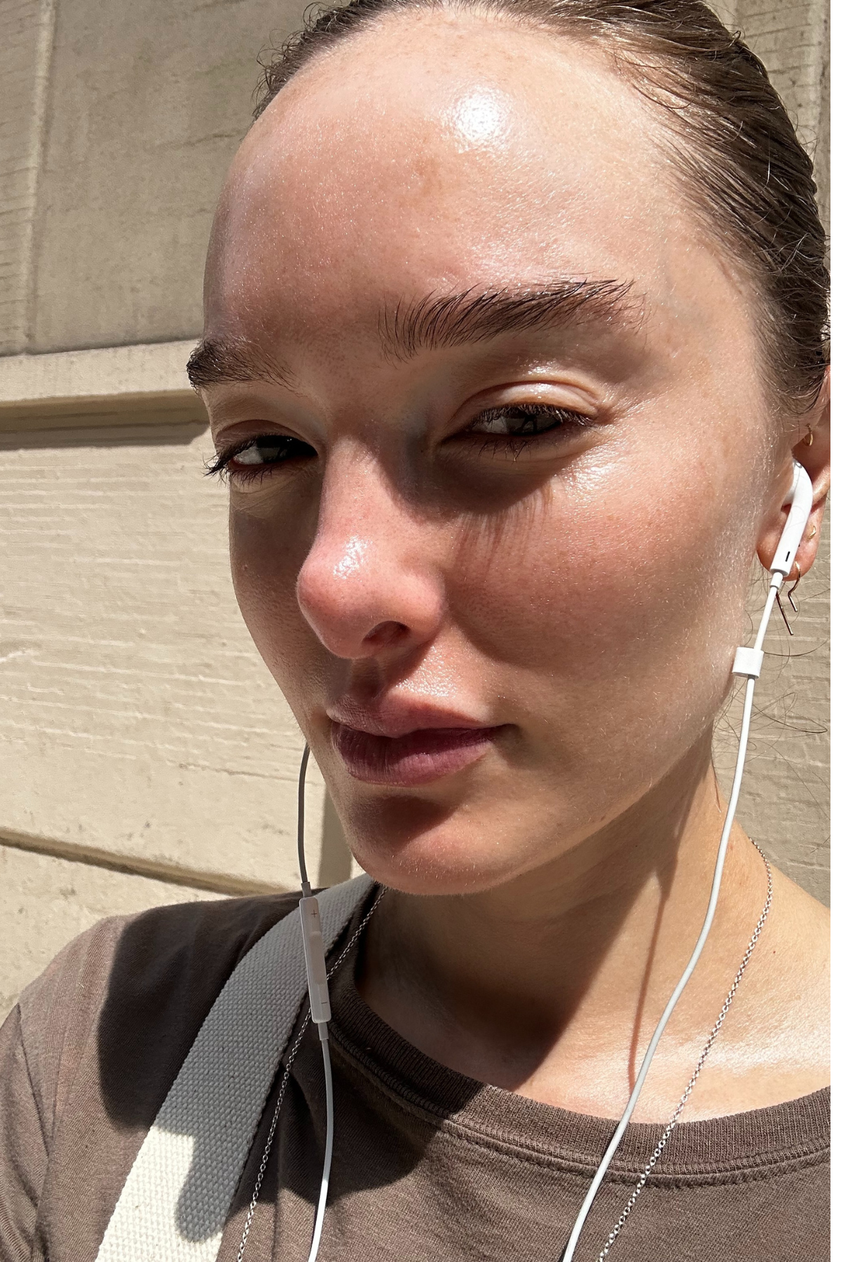 Hannah Baxter with bare skin and headphones