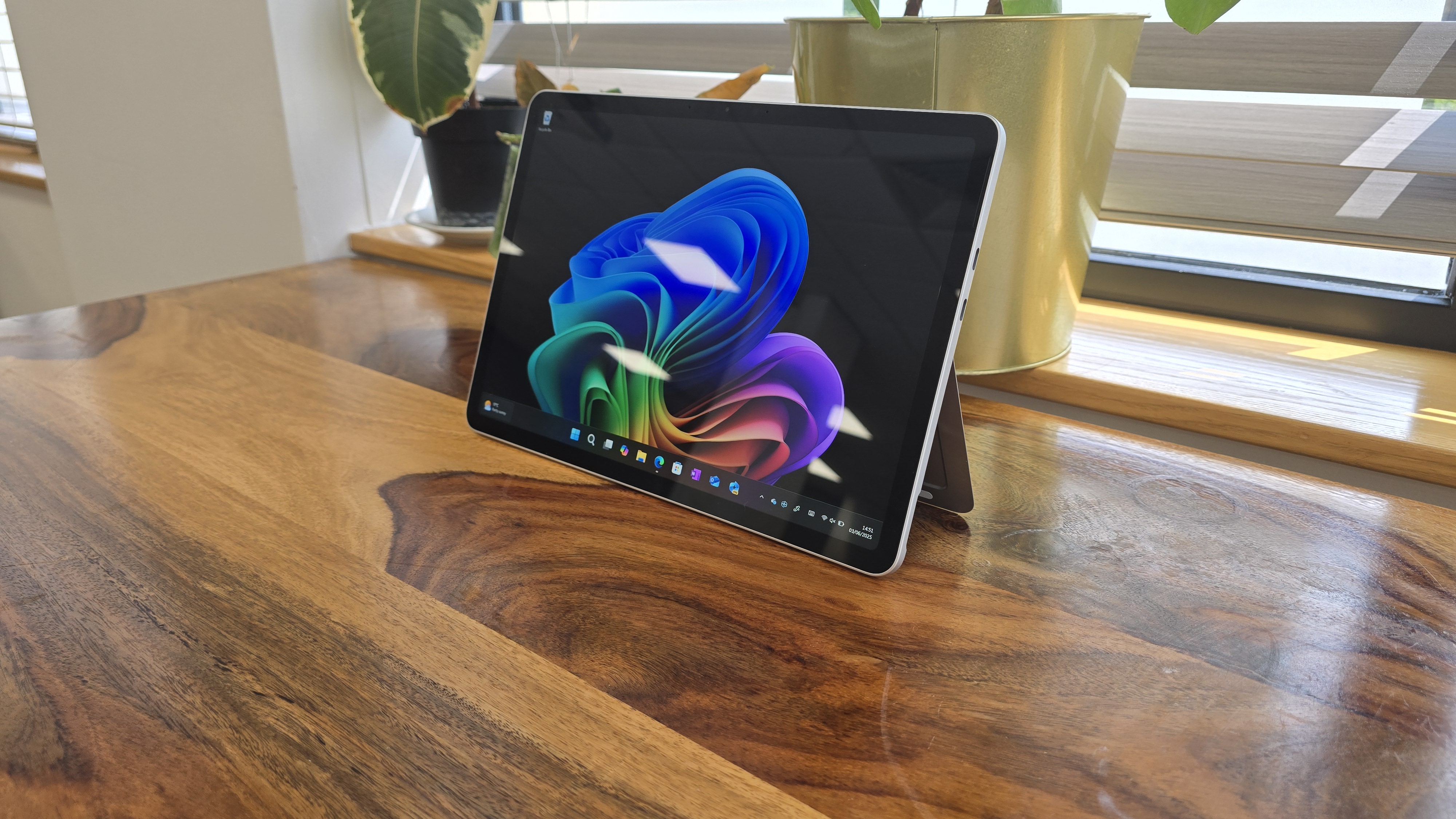 Microsoft Surface Pro 12 tablet on wooden table in relaxed cafe