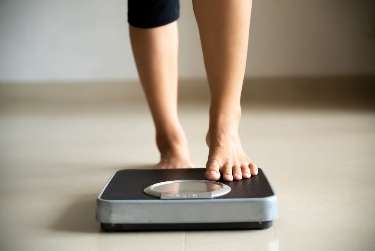 woman getting onto the scales