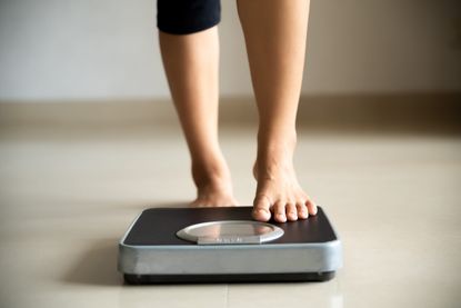 woman getting onto the scales