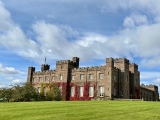 Red and yellow ivy grows up the side of the brick Scone Palace in Perthshire, Scotland