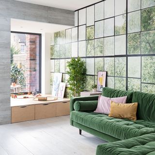 Open-plan living space with photorealistic nature mural panels behind sofa