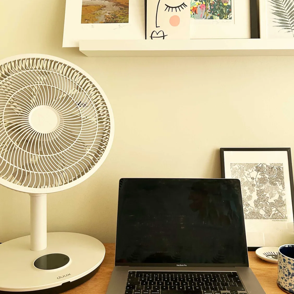Duux Whisper Flex 2 next to a laptop on a desk