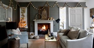 Stylish grey living room decorated for Christmas with paper chains hung around the room to show Christma decorating ideas