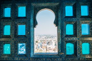 Indian style window and Udaipur city view from City Palace in India
