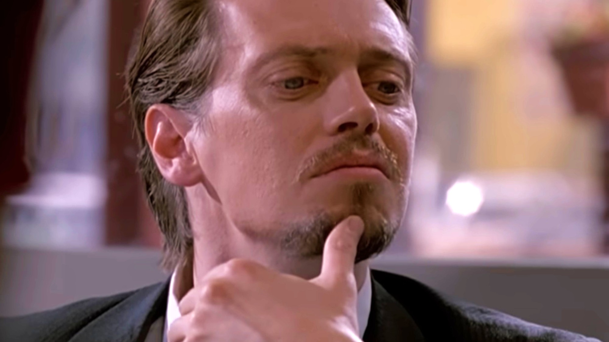 Steve Buscemi with his thumb on his chin in Reservoir Dogs