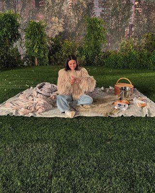 A photo of Selena Gomez wearing a cream-colored Yeti coat after getting engaged to boyfriend Benny Blanco.