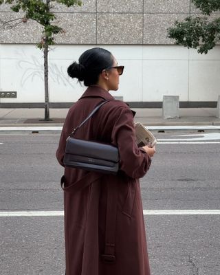 Influencer wears a burgundy coat.