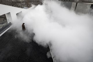 man standing in lots of smoke