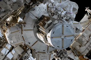 NASA astronaut Raja Chari (at top, right) and European Space Agency (ESA) astronaut Matthias Maurer (top, left) work together outside the U.S. Quest Airlock at the start of their spacewalk outside of the International Space Station on Wednesday, March 23, 2022.