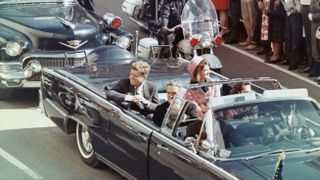 US President John F Kennedy, First Lady Jacqueline Kennedy, Texas Governor John Connally, and others smile at the crowds lining their motorcade route in Dallas, Texas, on November 22, 1963. Minutes later the President was assassinated as his car passed through Dealey Plaza.