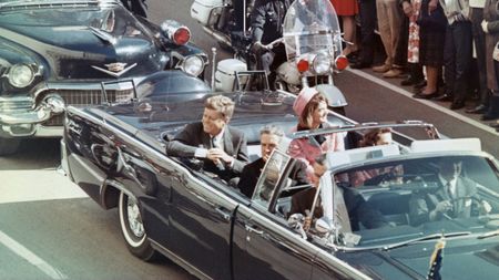 US President John F Kennedy, First Lady Jacqueline Kennedy, Texas Governor John Connally, and others smile at the crowds lining their motorcade route in Dallas, Texas, on November 22, 1963. Minutes later the President was assassinated as his car passed through Dealey Plaza.