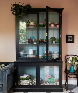 navy dresser unit with glass doors and the inside painted duck egg blue