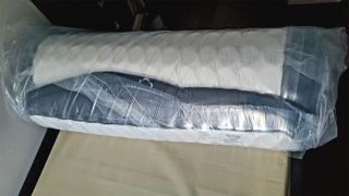 The DreamCloud Mattress shown wrapped in the protective plastic it arrived in for review