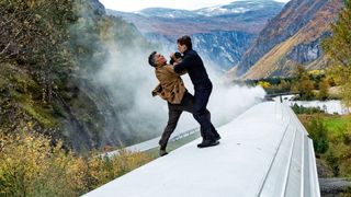 Gabriel and Ethan Hunt wrestle on a train carriage roof in Mission Impossible: Dead Reckoning - Part One