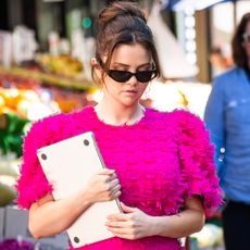 Selena Gomez in New York City wearing a pink puff sleeve dress and sunglasses