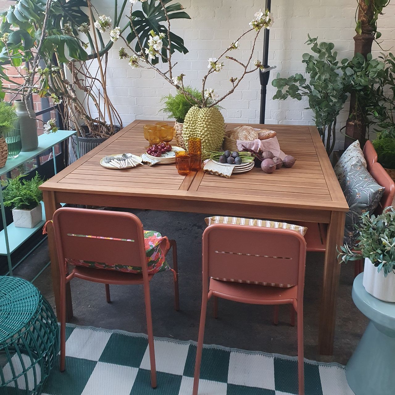 A wooden garden table with metal chairs at the La Redoute spring/summer 2025 press showcase