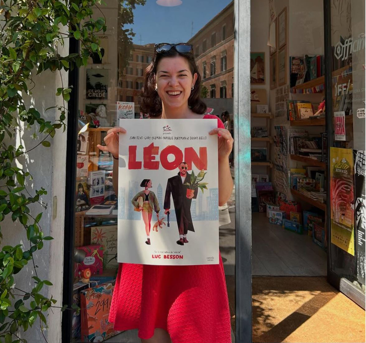 Artist sketchbook; a woman holds a poster and stands in front of a cafe