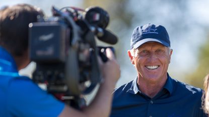 Greg Norman smiles during television interview
