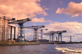 Former Clydebank Cranes line the riverbank at John Brown & Co, John Browns Shipyard, River Clyde, Glasgow Scotland, United Kingdom