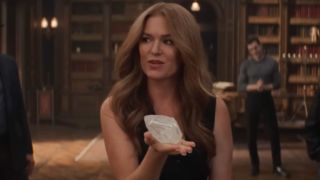 Isla Fisher as Henley in Now You See Me: Now You Don't. She's holding up a diamond with her left hand.
